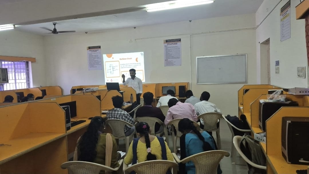 Mentor guiding an intern on embedded systems hardware